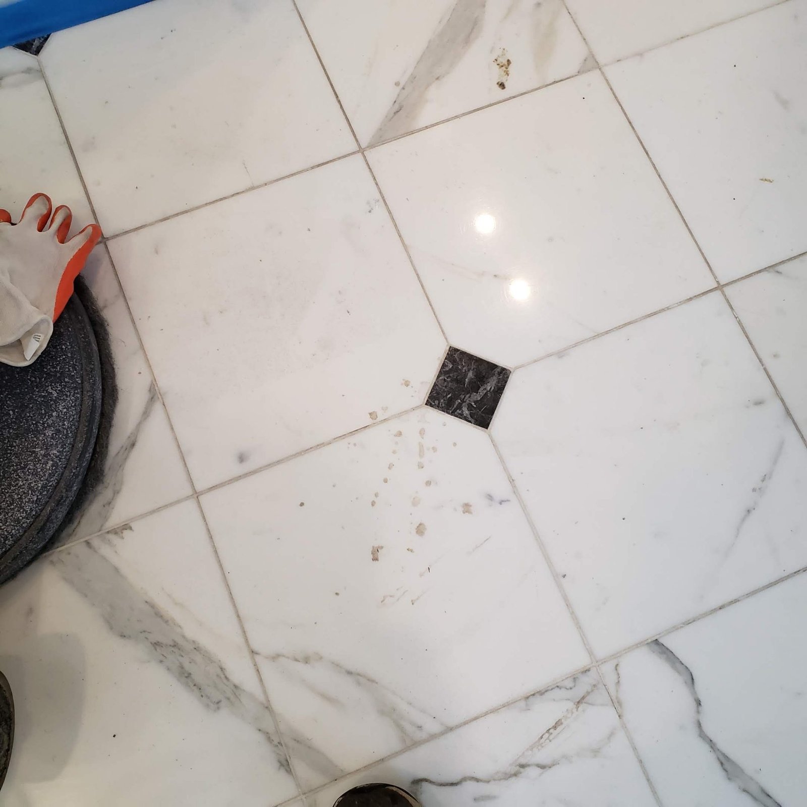 White marble tile floor dull and stained before restoration and polishing
