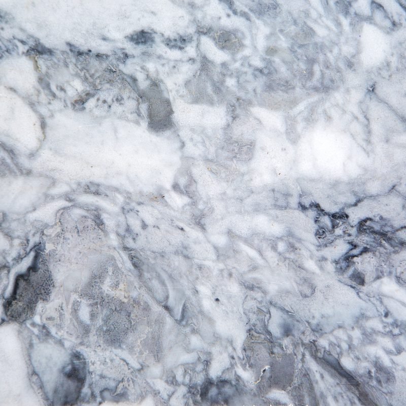 Close-up of a polished marble surface with natural grey and white veining.